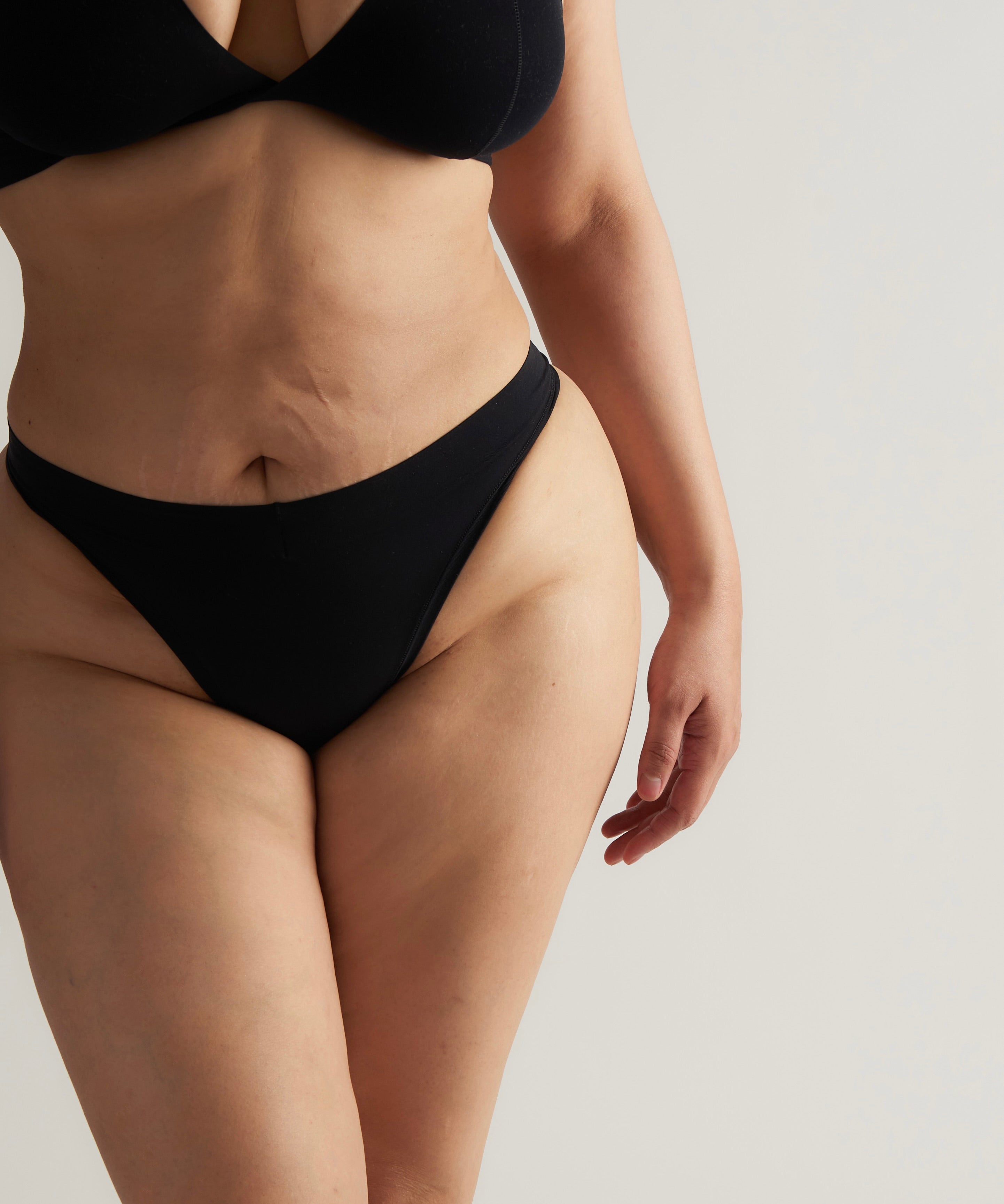 Woman standing wearing the Thong in black