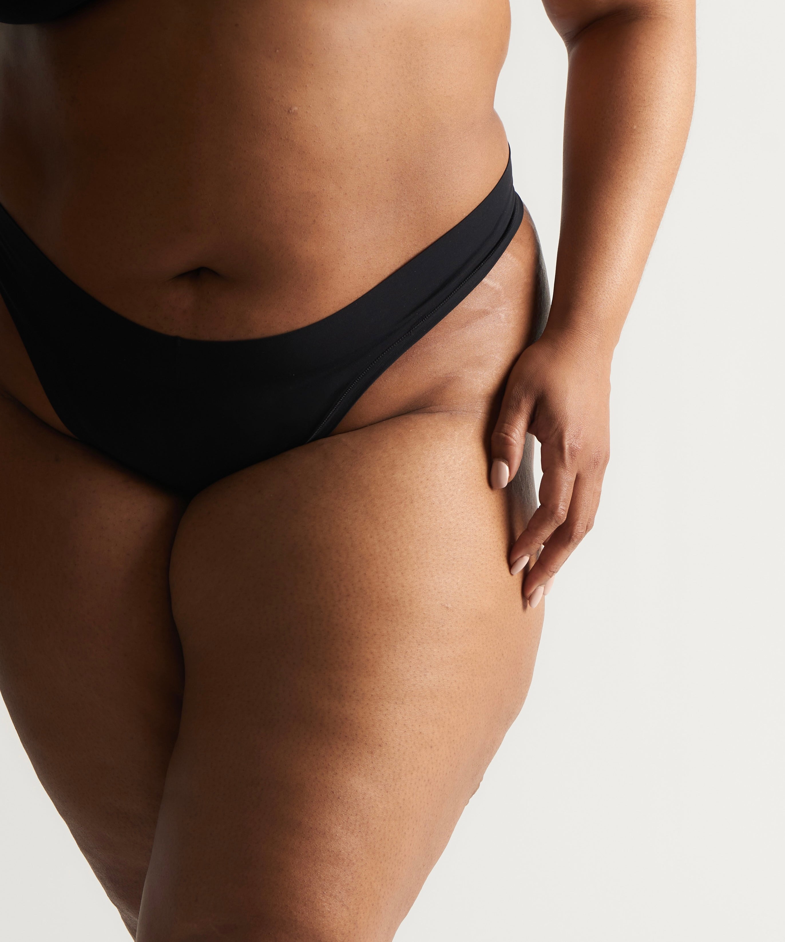 Woman standing wearing the Thong in black