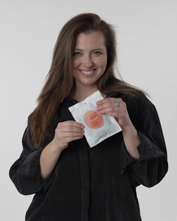 GIF of woman tearing open the Nuudii packaging 