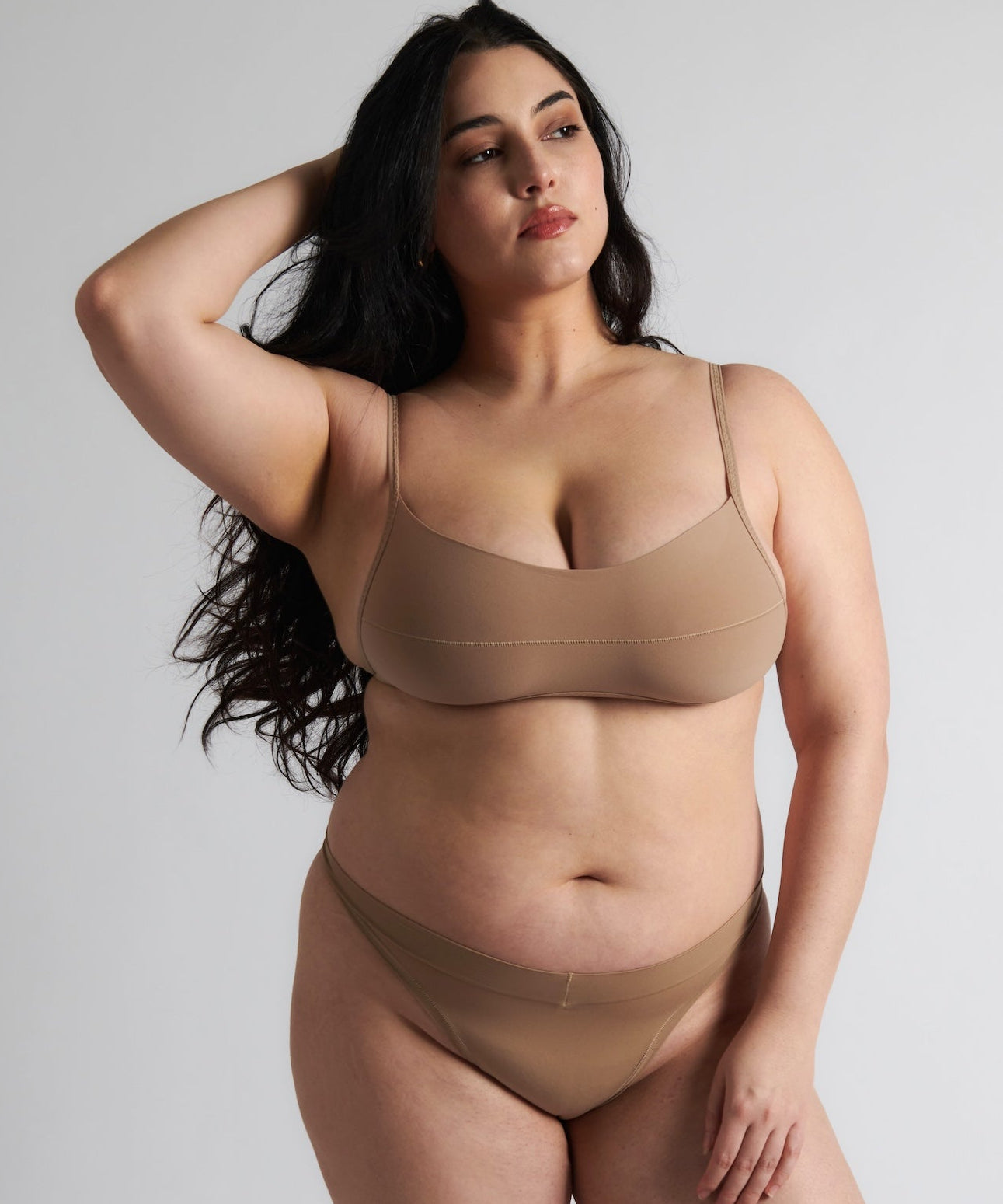 A woman wearing a light scoop system and matching bottoms