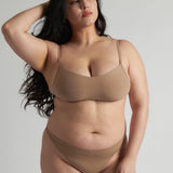 A woman wearing a light scoop system and matching bottoms