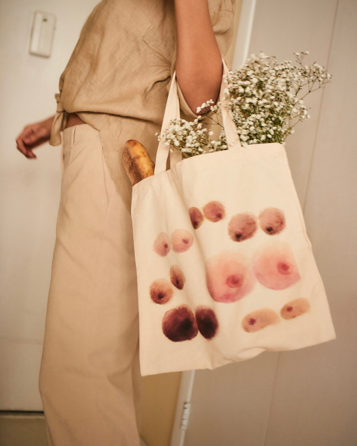 Woman holding Nuudii Boob Bag with flowers inside