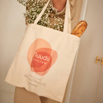 Woman holding Nuudii Boob Bag with flowers inside