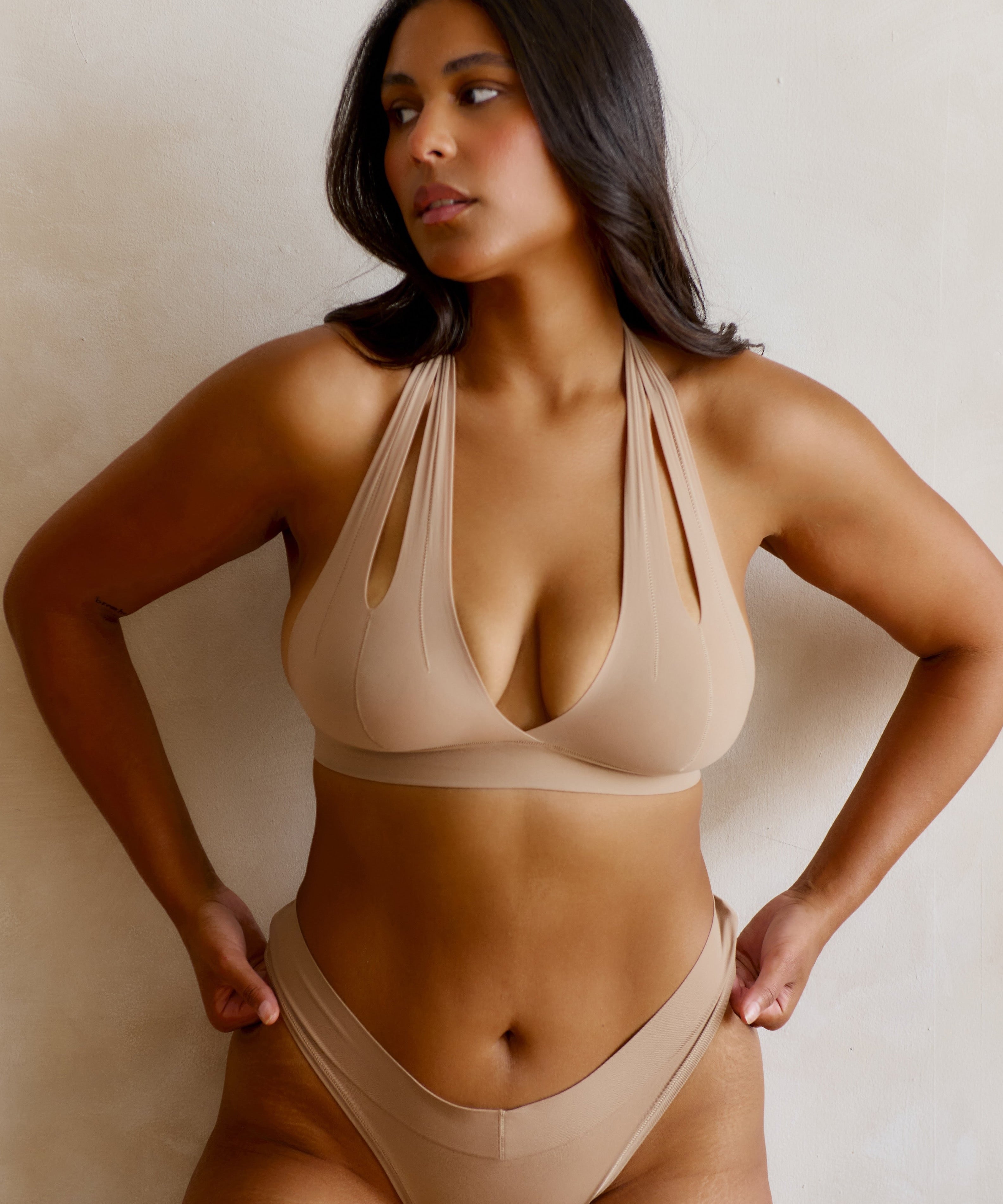  Beige halter system worn by a person on a plain background