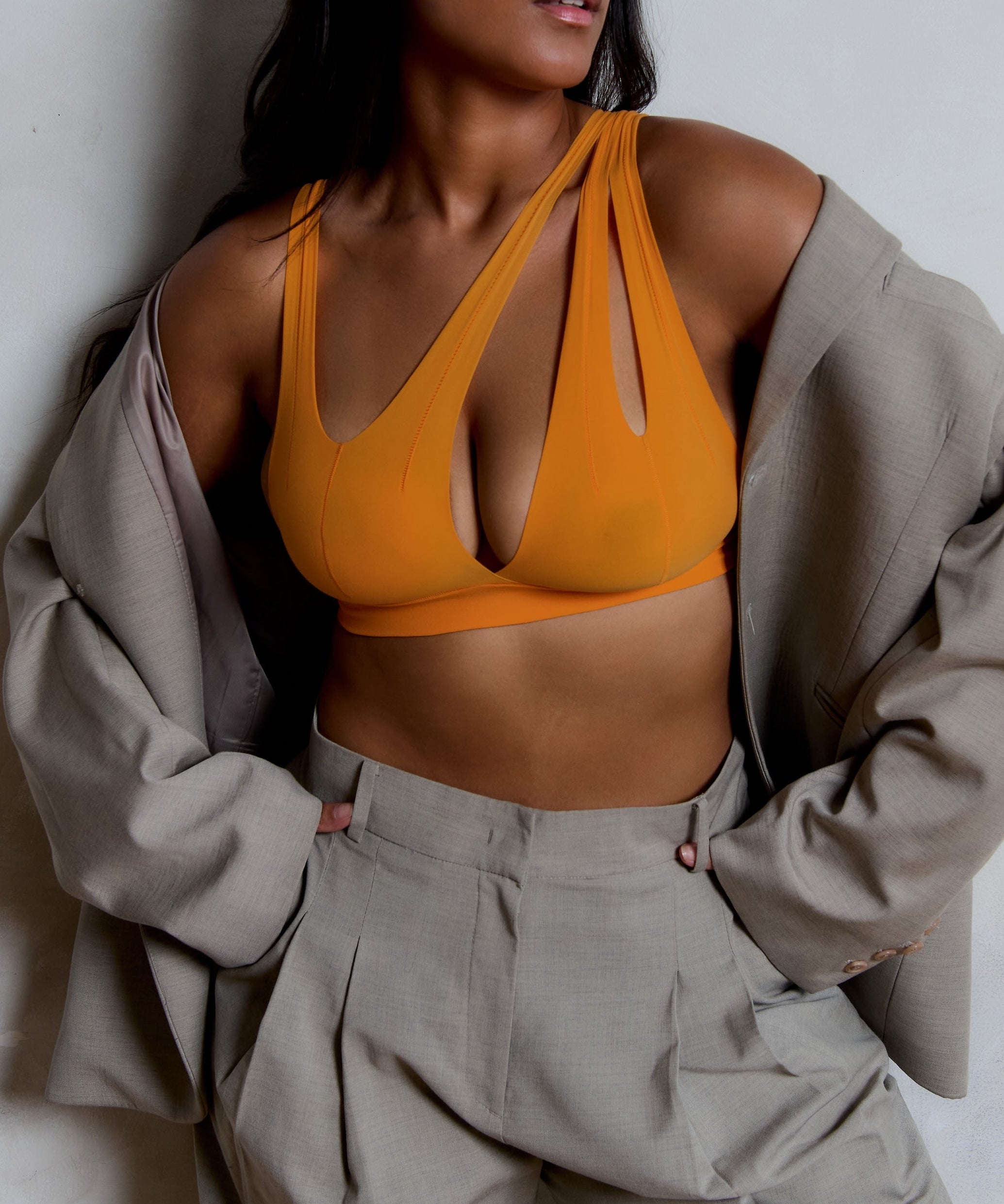 person wearing a tangerine tee system on a plain background