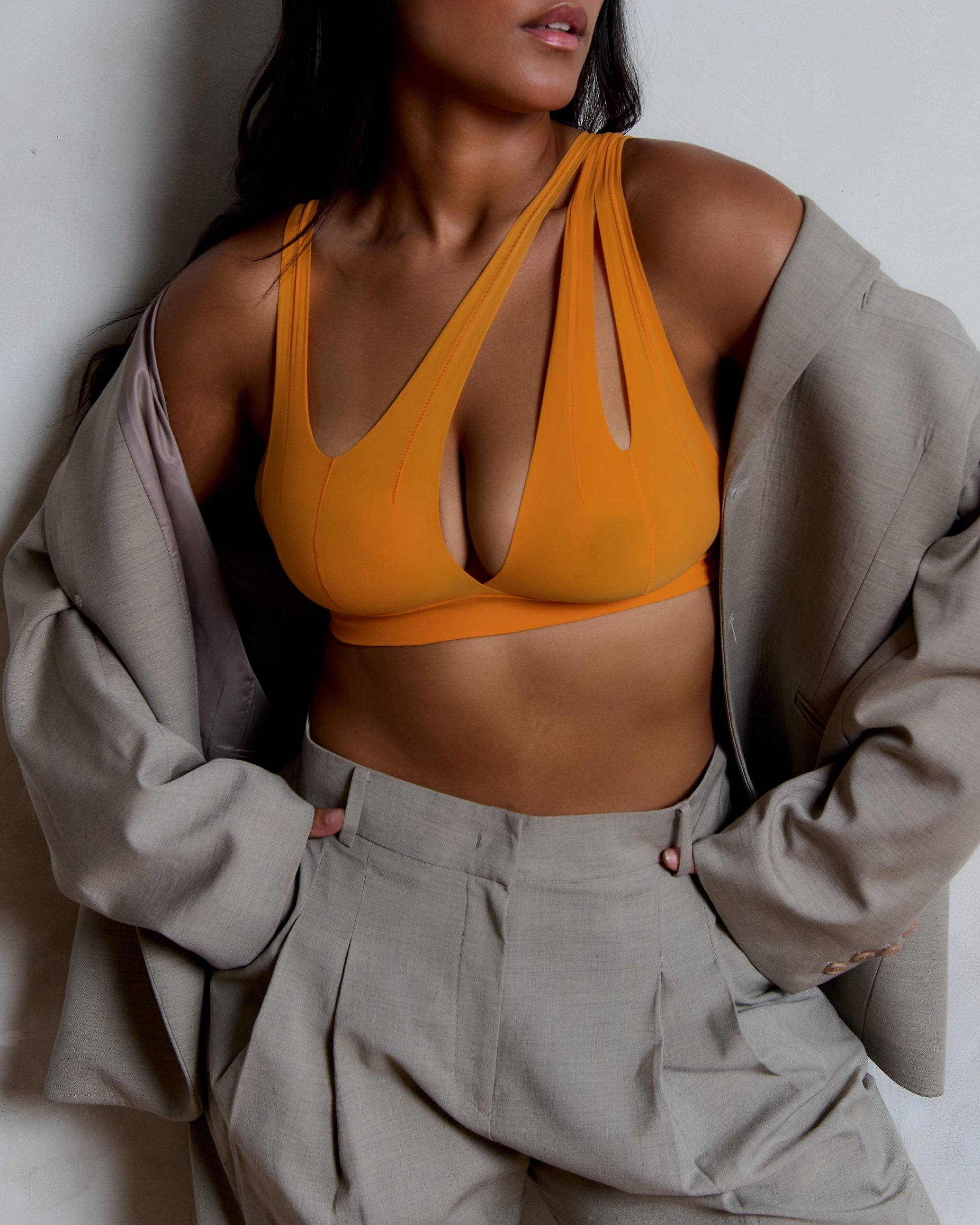 person wearing a tangerine tee system on a plain background