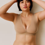 A person wearing a beige vii system against a plain background.