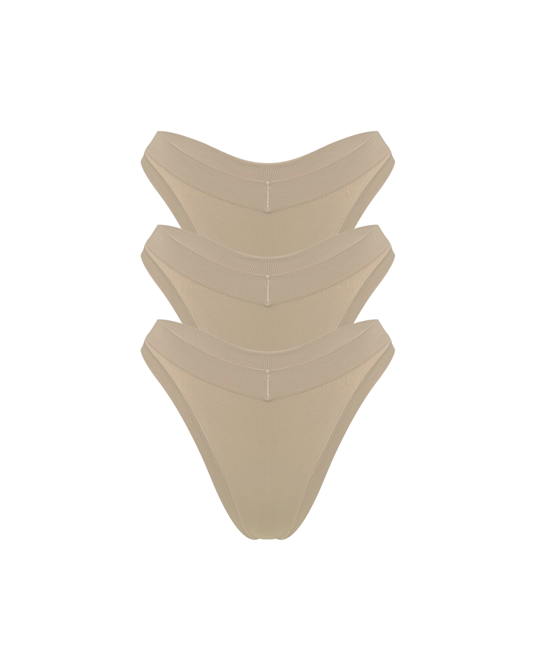Three stacked nude beige thong underwear stacked on a solid white background.