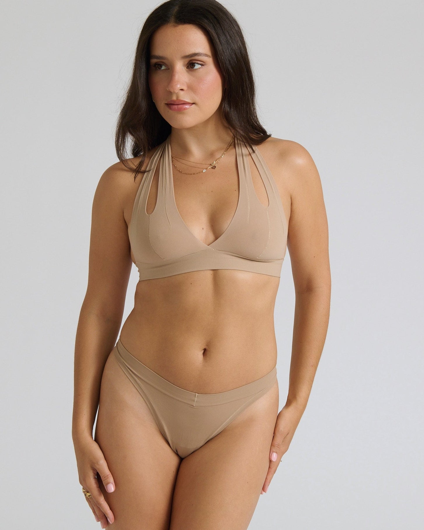 Beige halter system worn by a person on a plain background
