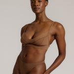 woman in brownz cami system on a plain background