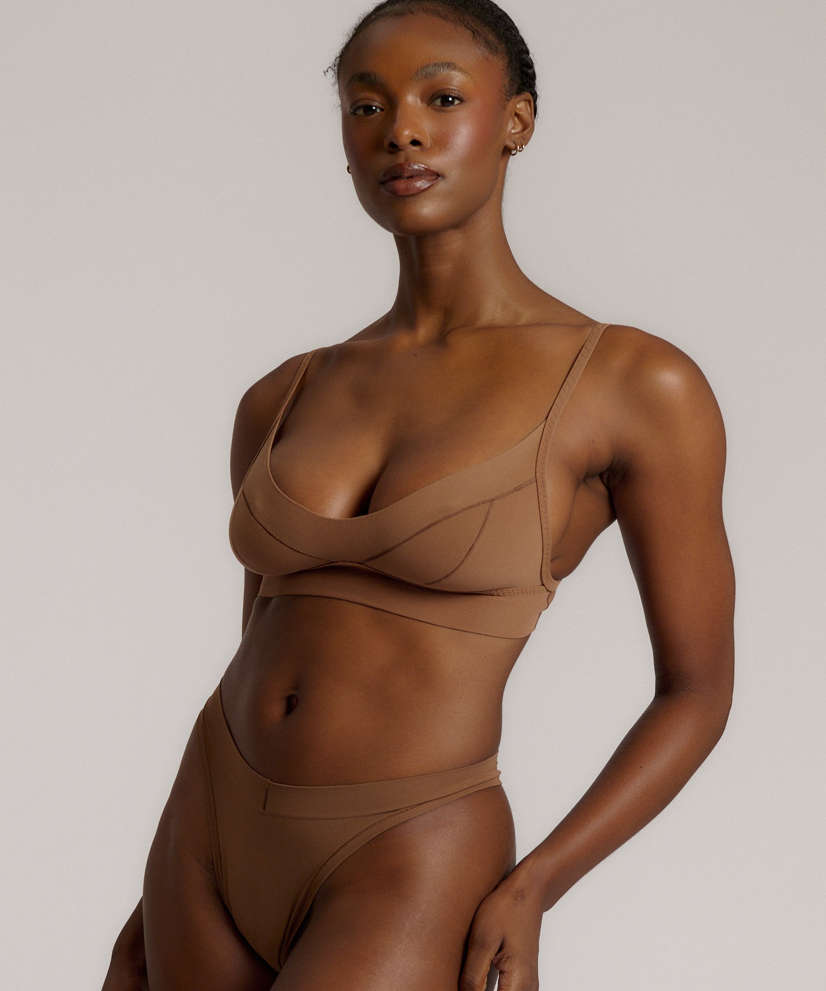 woman in brownz cami system on a plain background