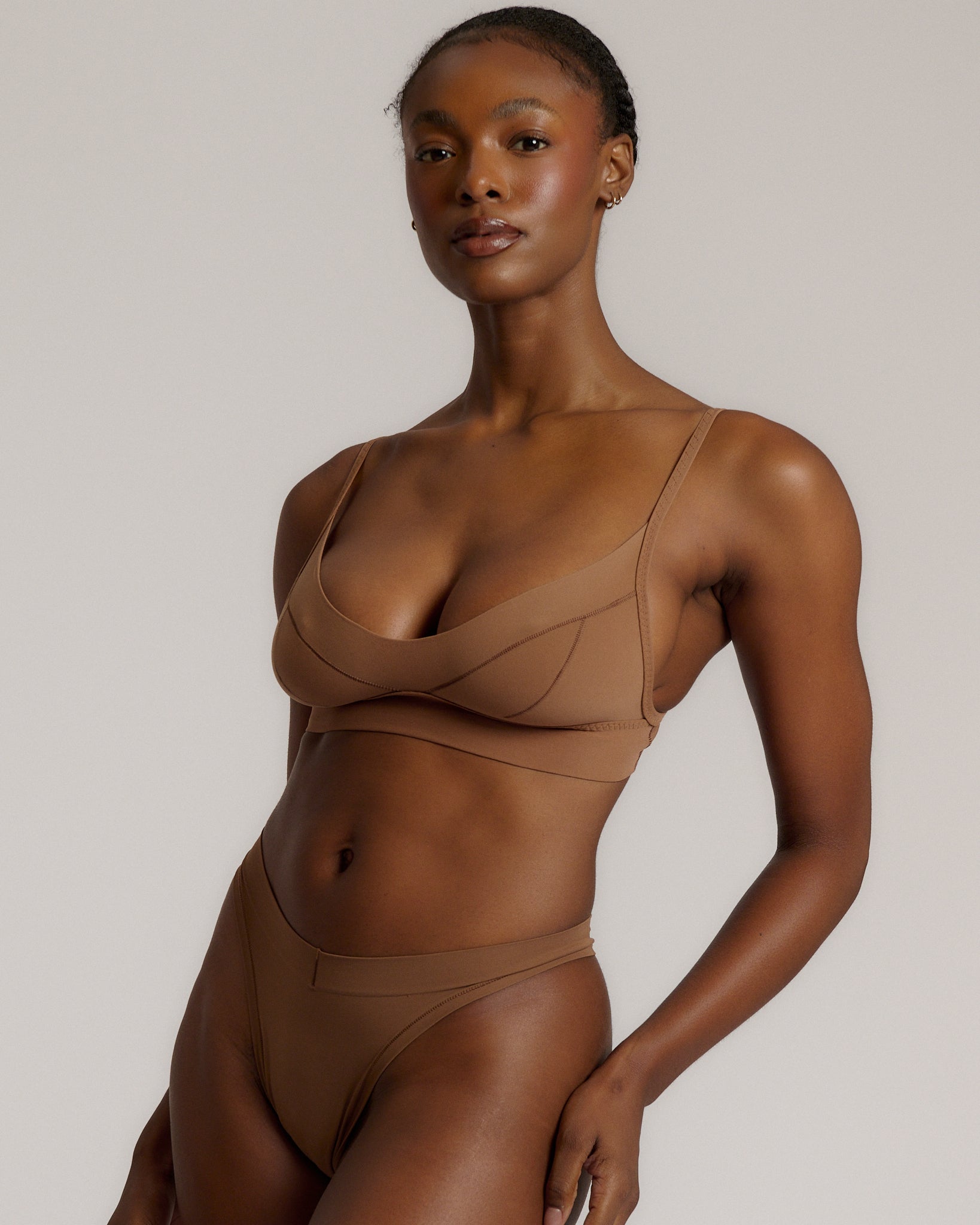 woman in brownz cami system on a plain background
