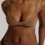woman in brownz cami system on a plain background