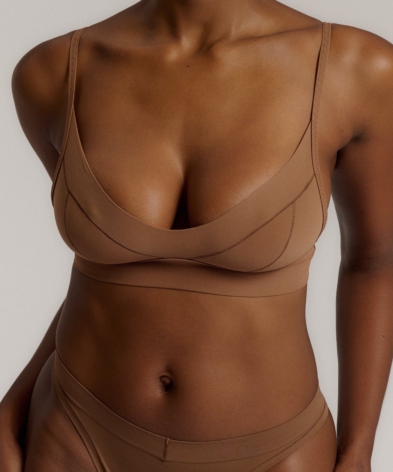 woman in brownz cami system on a plain background