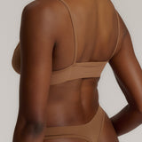 woman in brownz cami system on a plain background