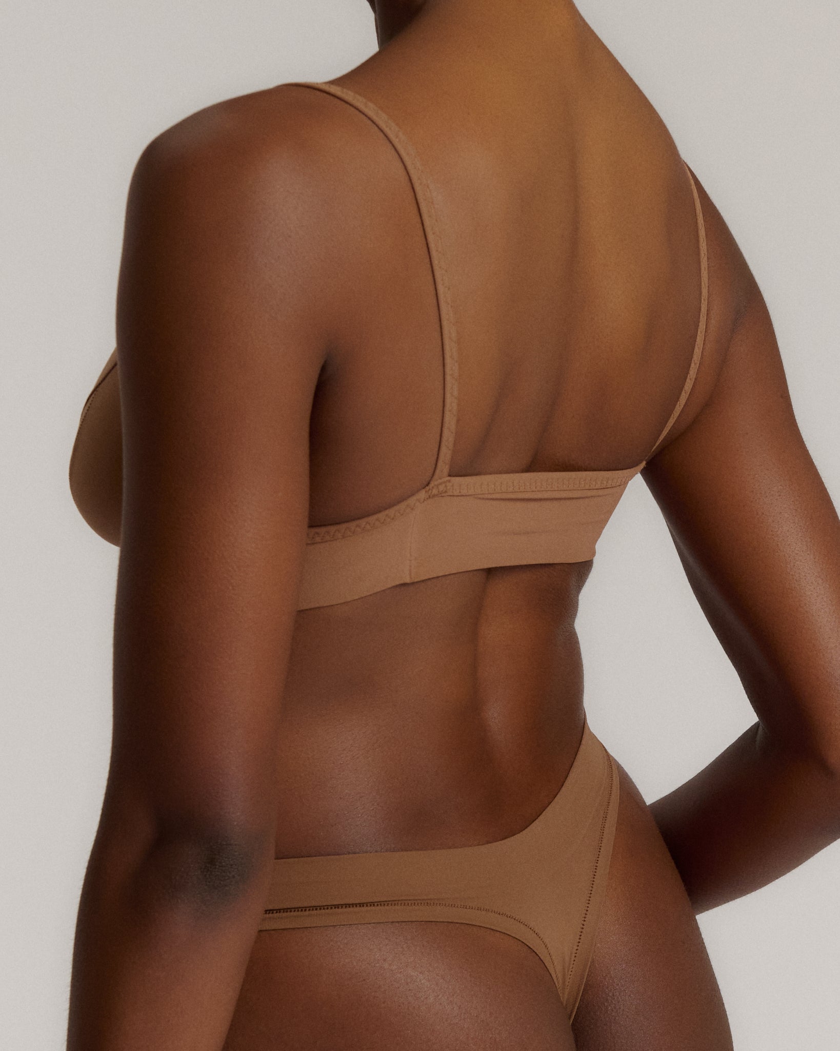 woman in brownz cami system on a plain background