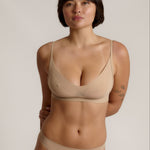 person wearing a light cami system on a plain background