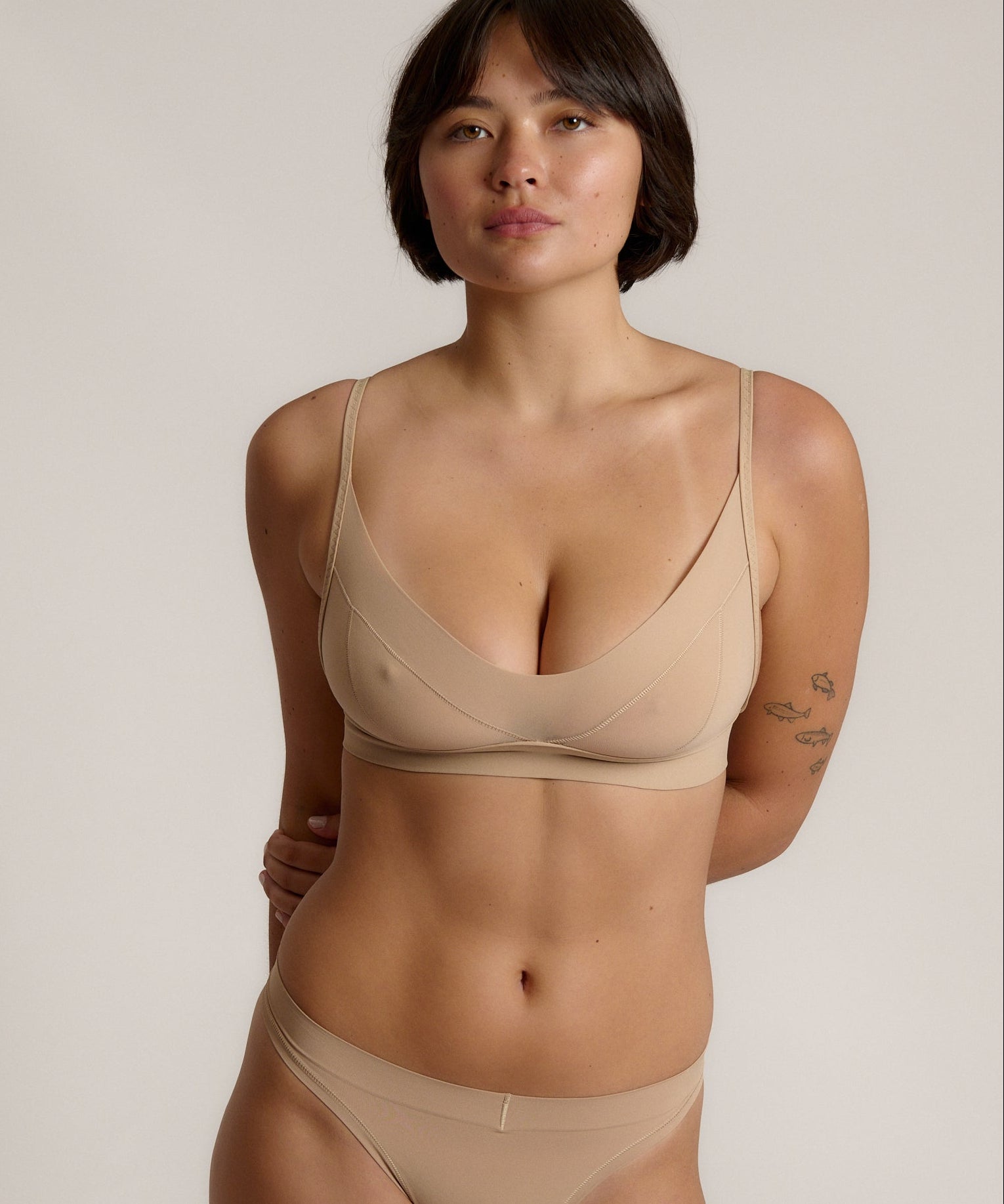 person wearing a light cami system on a plain background