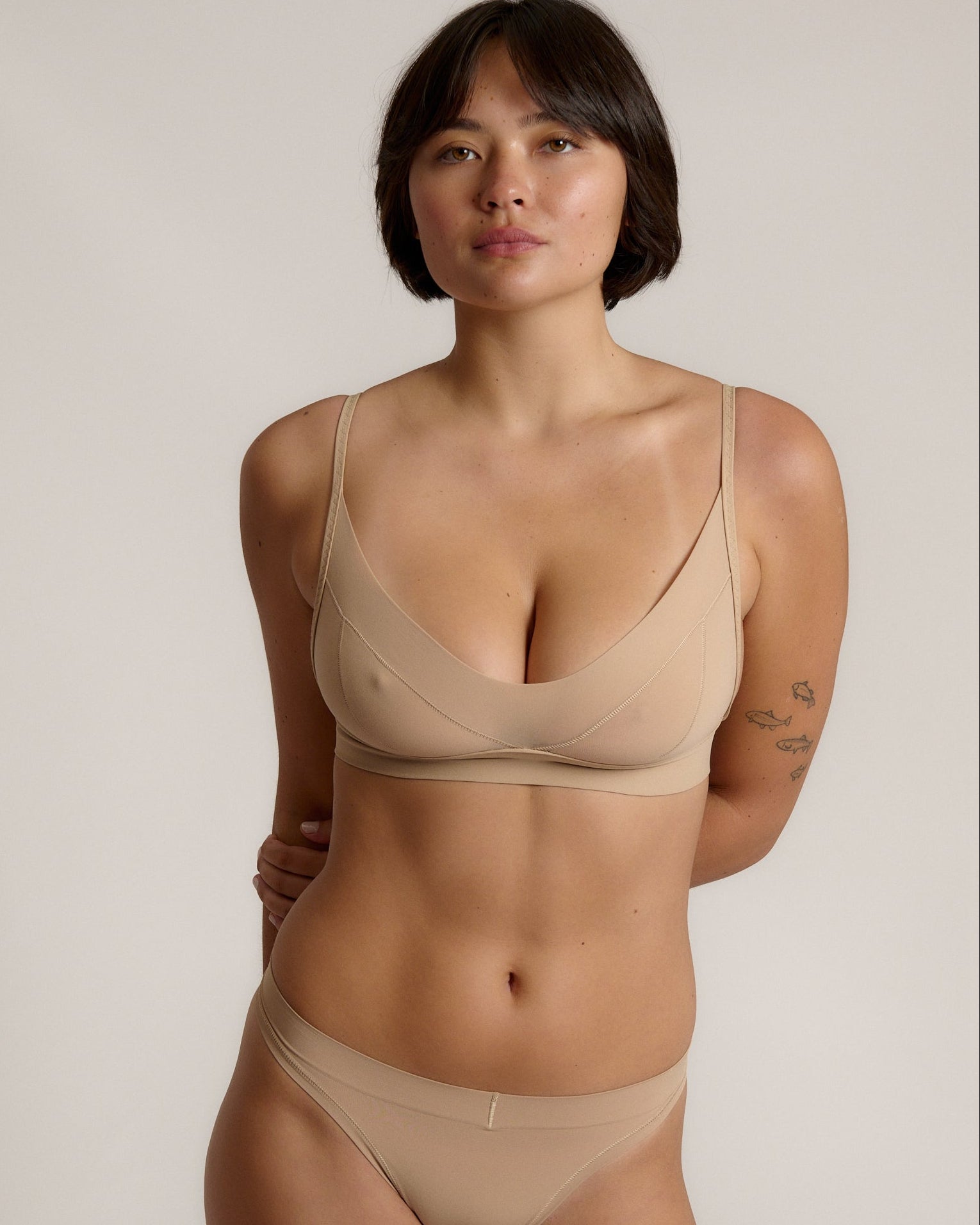 person wearing a light cami system on a plain background