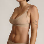 person wearing a light cami system on a plain background