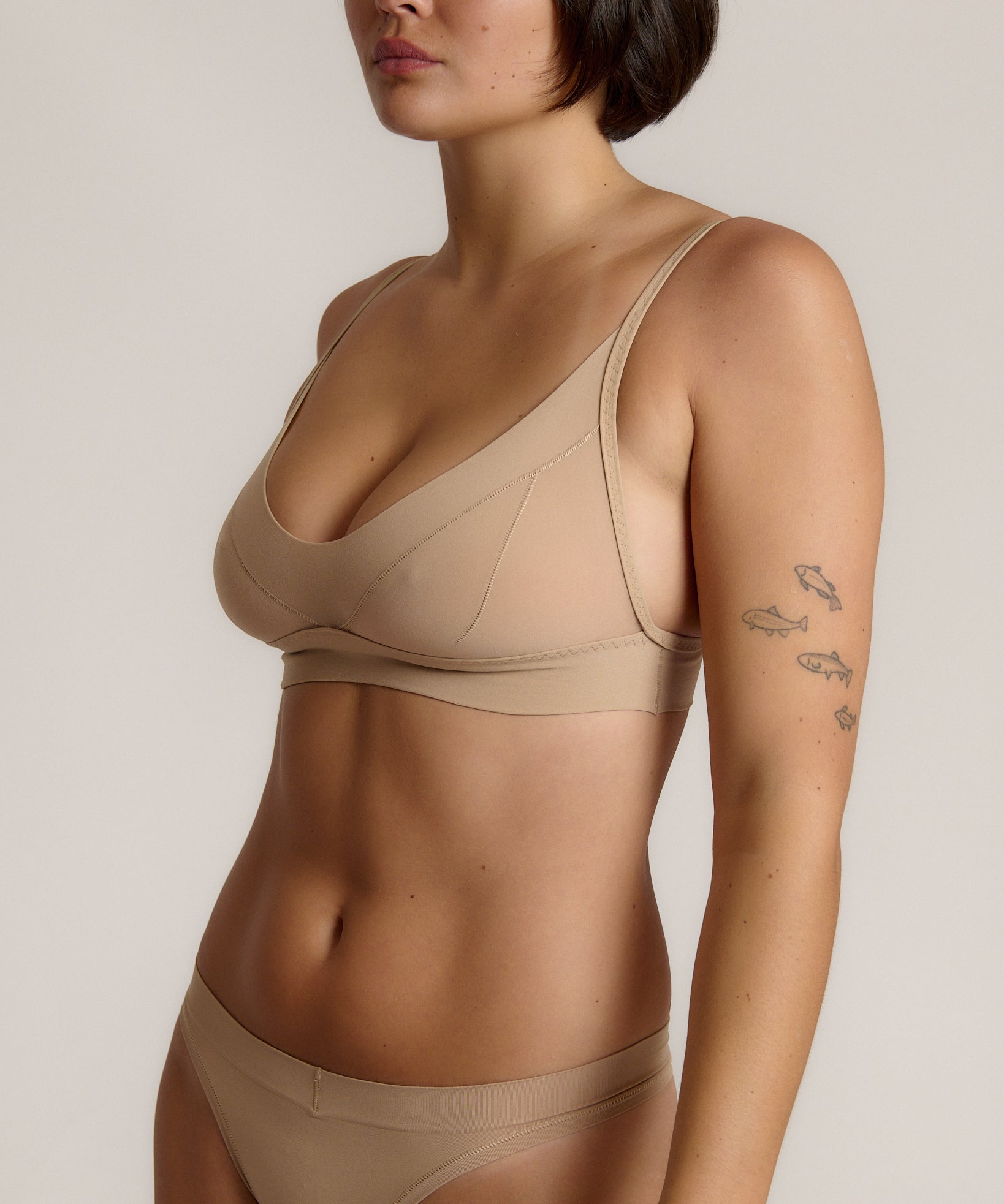 person wearing a light cami system on a plain background
