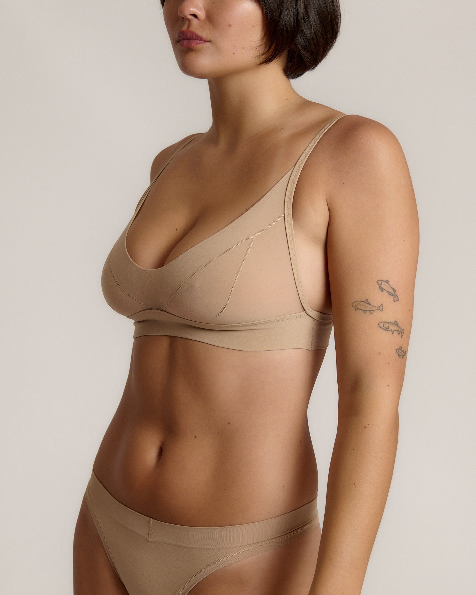person wearing a light cami system on a plain background