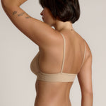 person wearing a light cami system on a plain background
