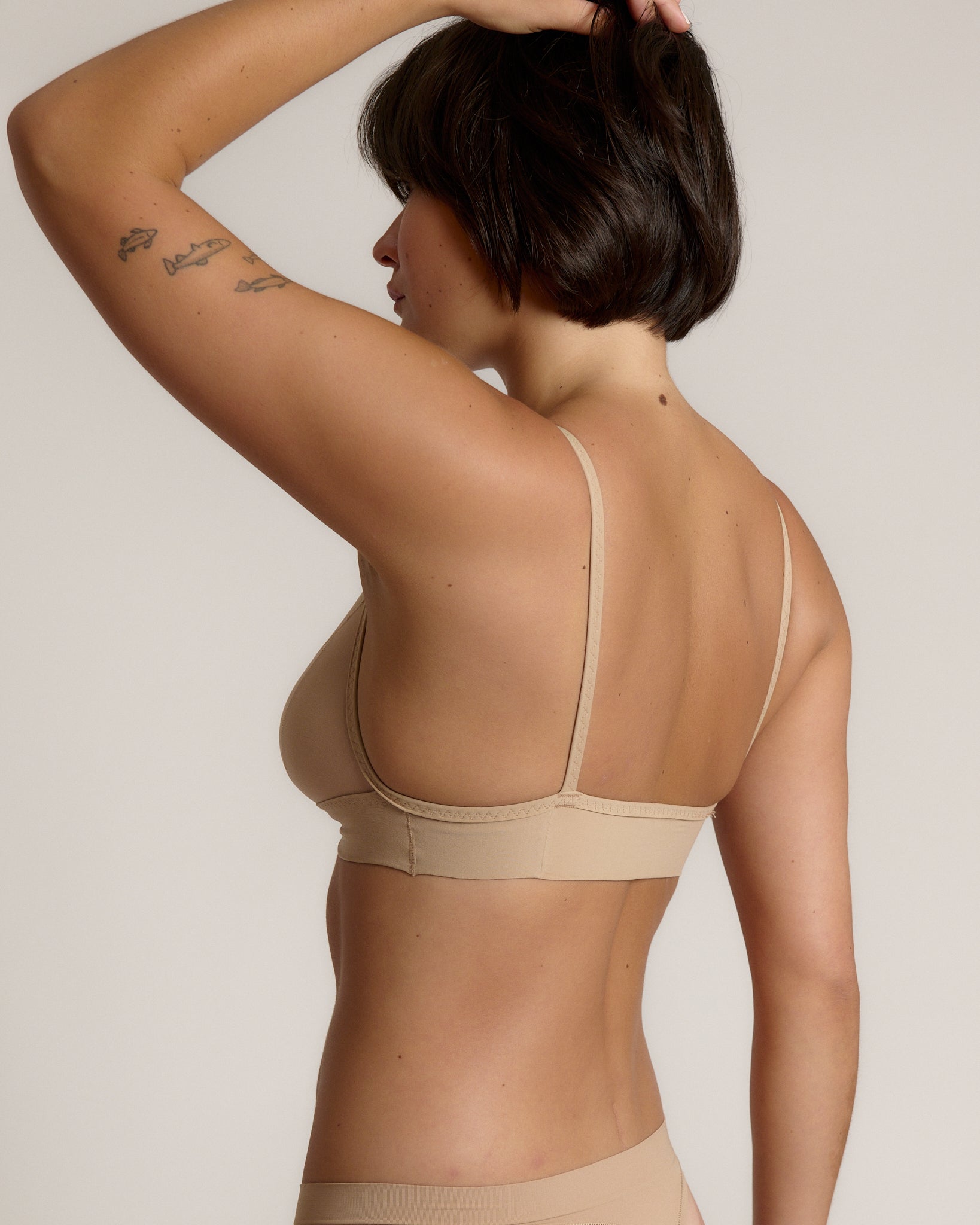person wearing a light cami system on a plain background