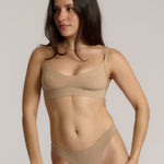 person wearing a light cami system on a plain background