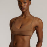 A woman wearing a brownz scoop system and matching bottoms