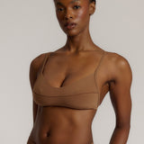 A woman wearing a brownz scoop system and matching bottoms