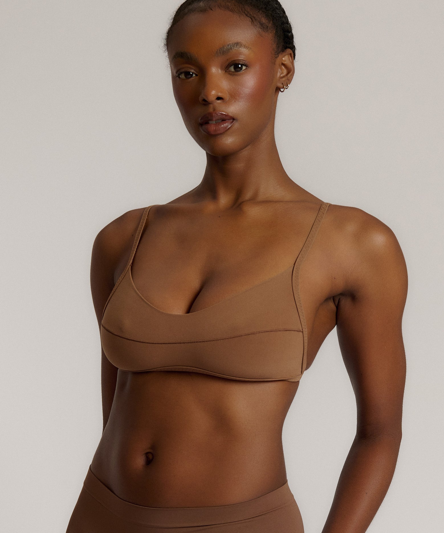 A woman wearing a brownz scoop system and matching bottoms
