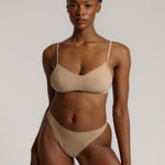 A woman wearing a light scoop system and matching bottoms