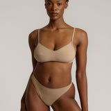 A woman wearing a light scoop system and matching bottoms