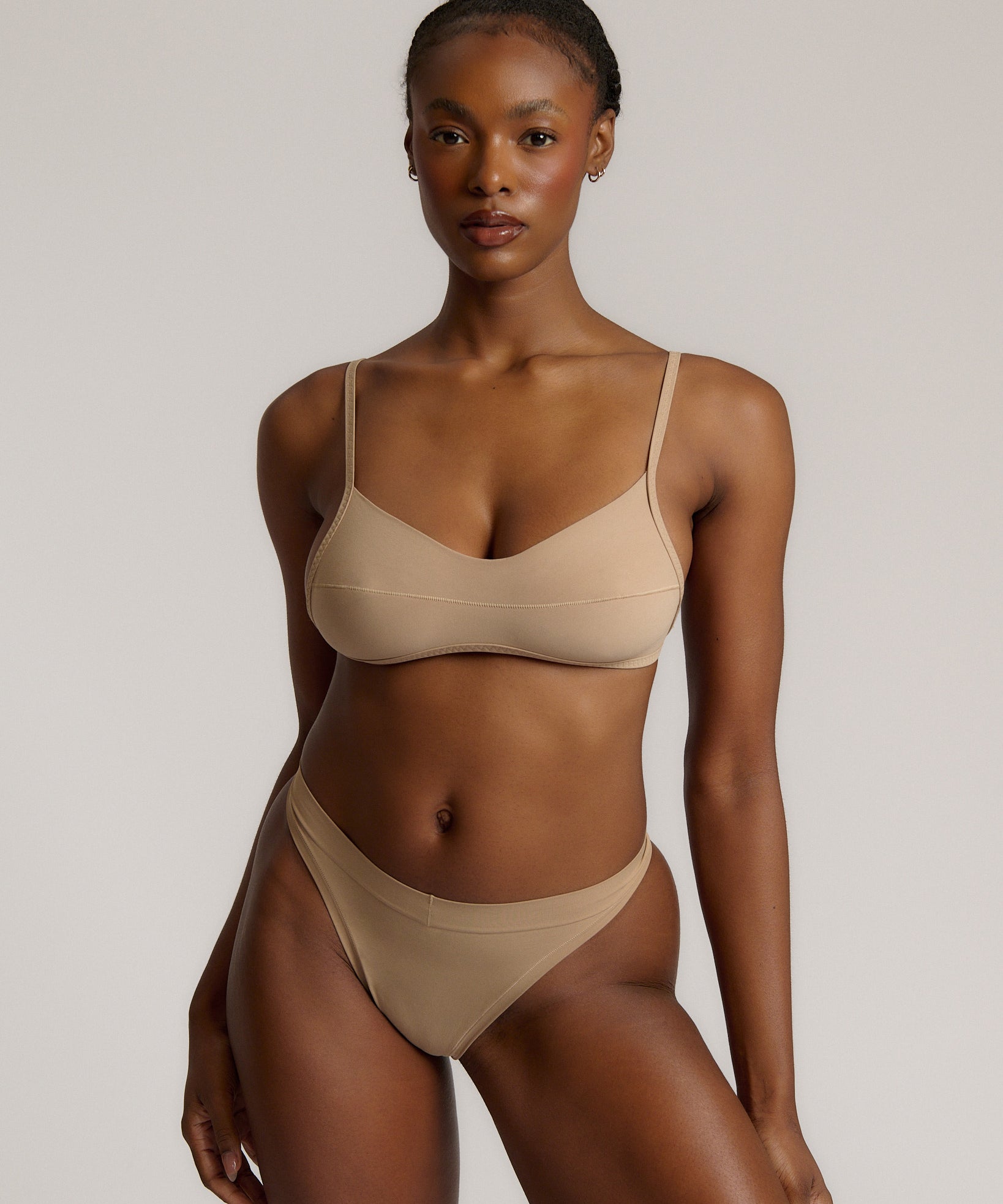 A woman wearing a light scoop system and matching bottoms