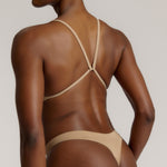 A woman wearing a light scoop system and matching bottoms