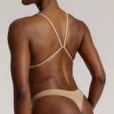 A woman wearing a light scoop system and matching bottoms