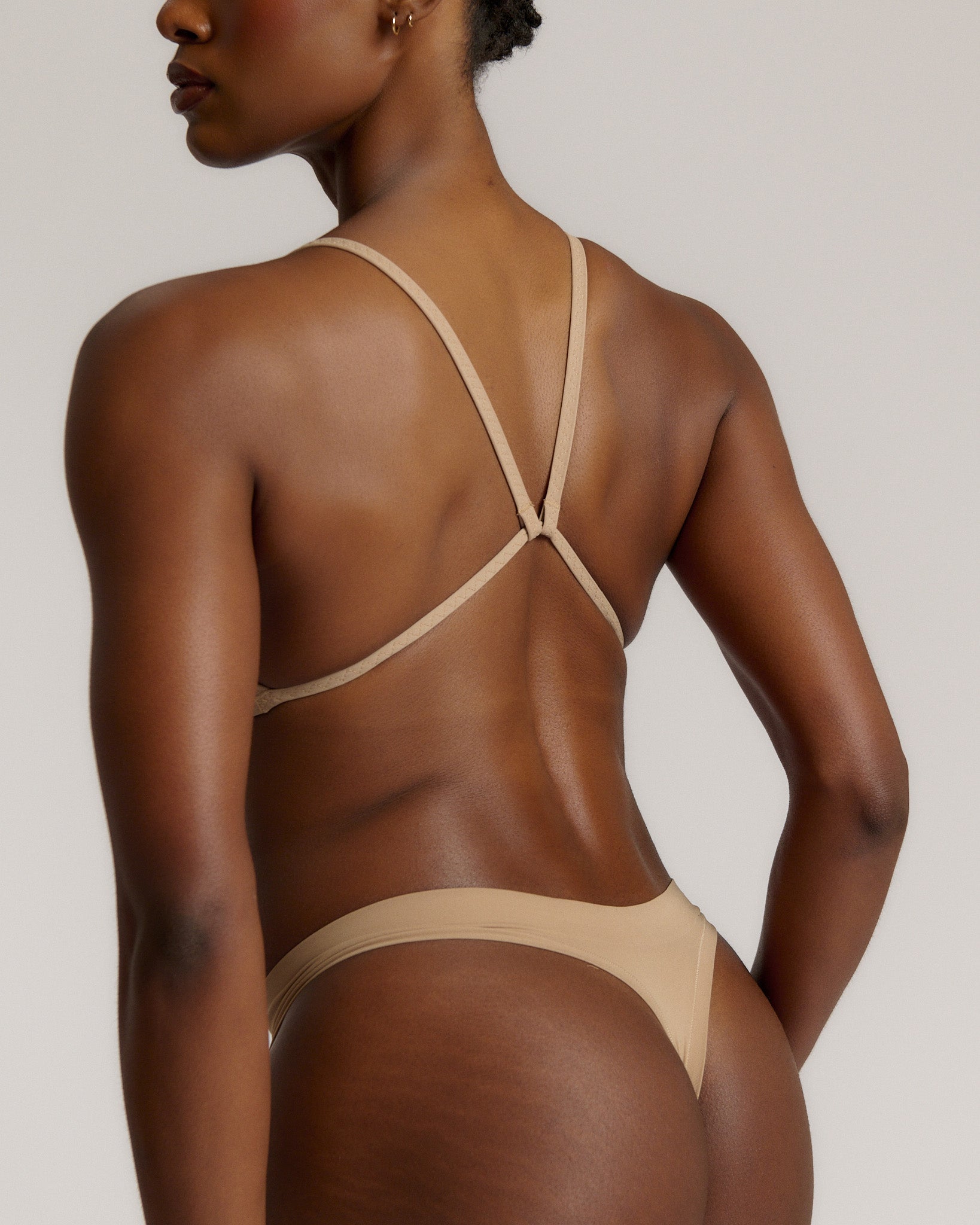 A woman wearing a light scoop system and matching bottoms