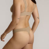 Woman wearing a light tee system against a plain background