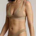 Woman wearing a light tee system against a plain background