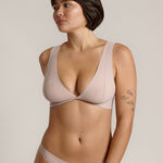 Woman wearing a dusk twist system against a plain background