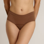 A person wearing a pair of brown, mid-rise women's underwear.