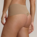 A pair of beige, mid-rise women's underwear.