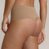 A pair of beige, mid-rise women's underwear.