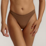Woman standing wearing the Thong in brownz