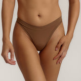 Woman standing wearing the Thong in brownz