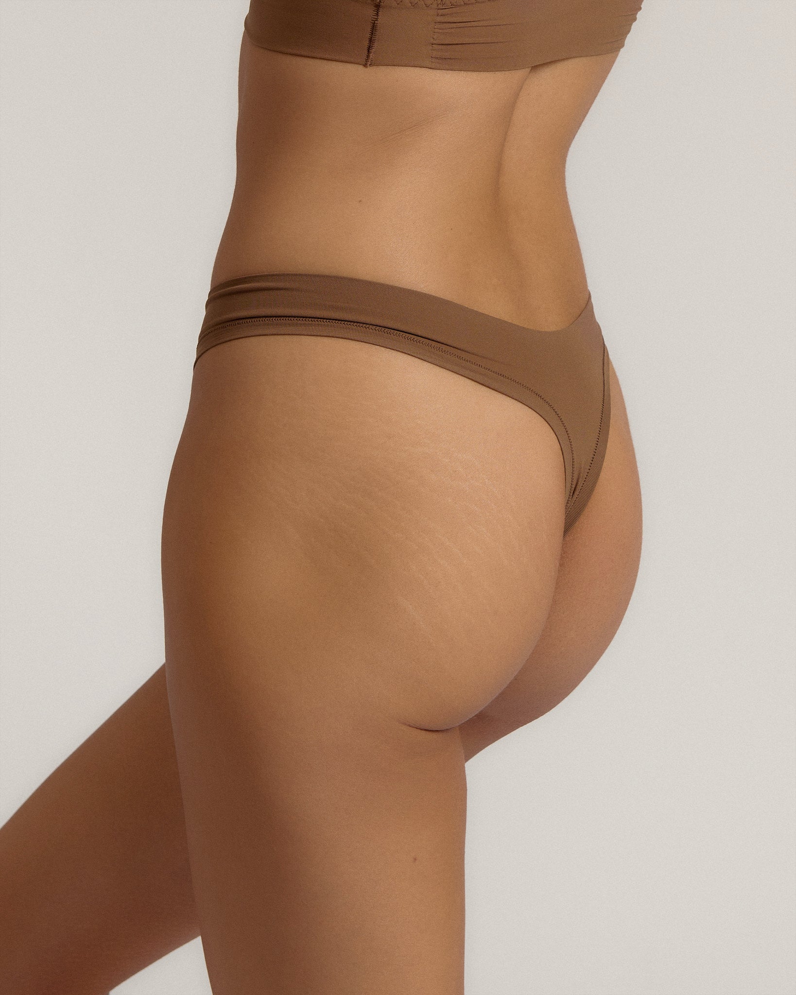 Woman standing wearing the Thong in brownz