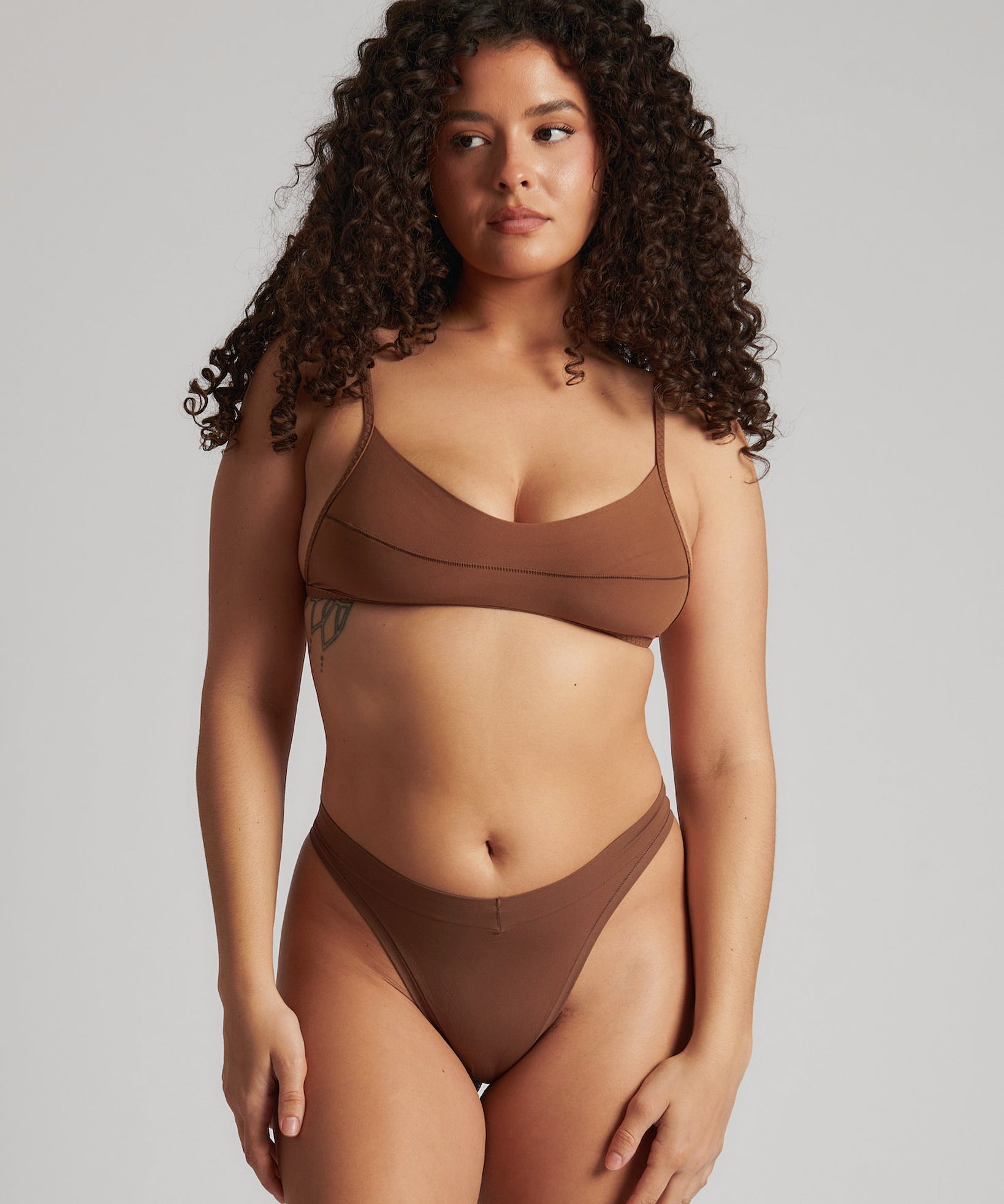 A woman wearing a brown scoop system and matching bottoms