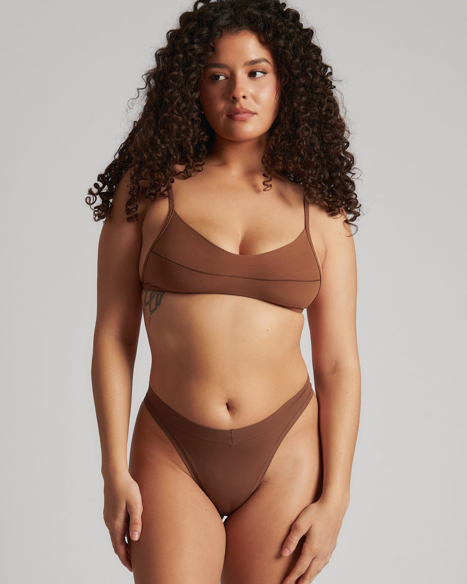 A woman wearing a brown scoop system and matching bottoms
