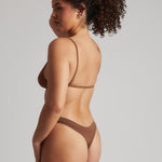 A woman wearing a brown scoop system and matching bottoms